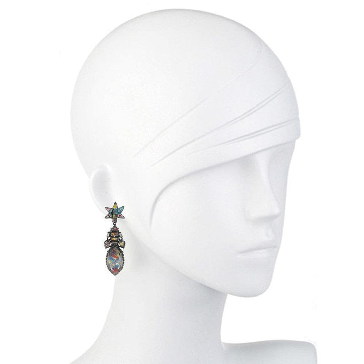 Colorful gemstone drop earrings with star accents, shown on a mannequin.