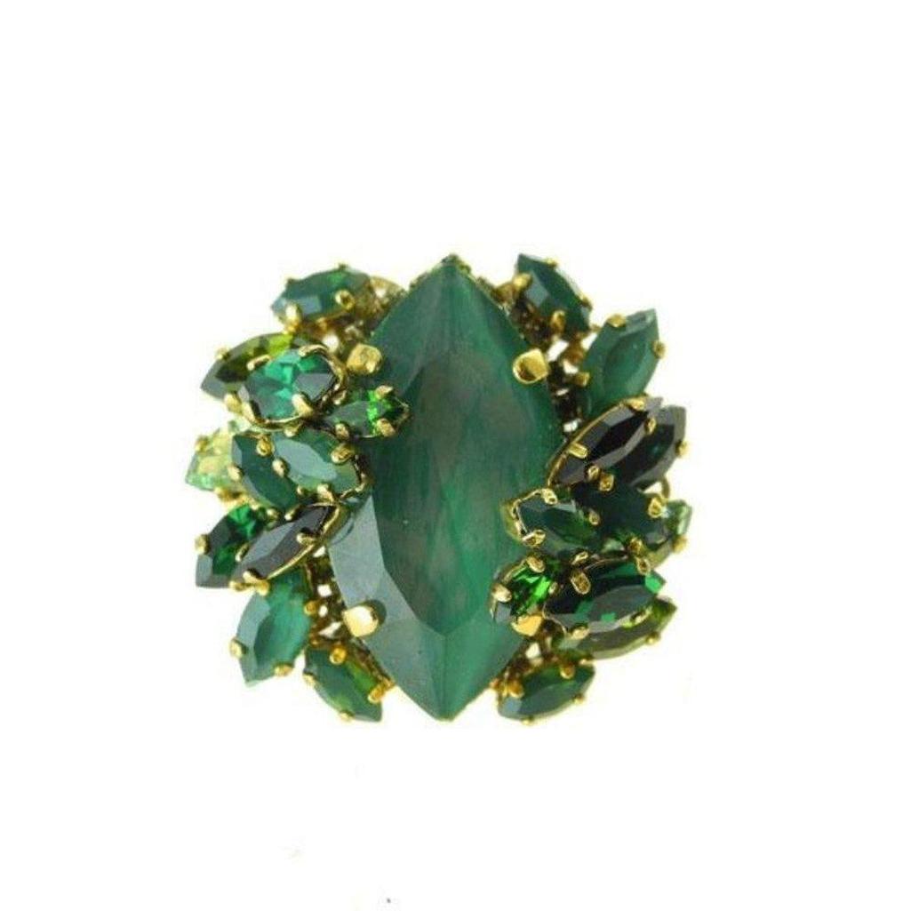 Girls On Film Green statement ring featuring a large emerald green stone, surrounded by smaller green and black crystals.