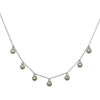 Mini Crystals silver necklace with delicate chain and seven small, ornate pendants.