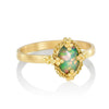 Oval Prong Black Opal ring in 18k gold with ornate detailing.