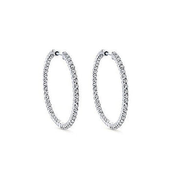 One-inch diamond hoop earrings, sparkling on white background.
