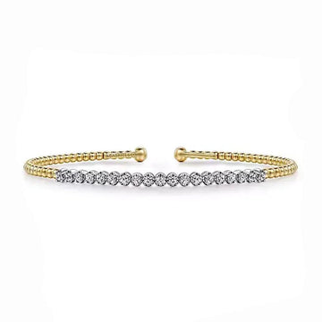 Diamond cuff bracelet in white and yellow gold, featuring beaded detailing.
