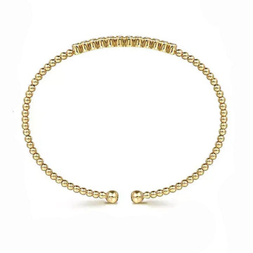 14K gold beaded bangle with a row of diamonds.
