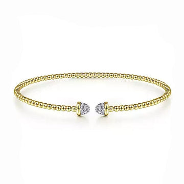 Beaded gold bangle bracelet with pave diamond accents.

