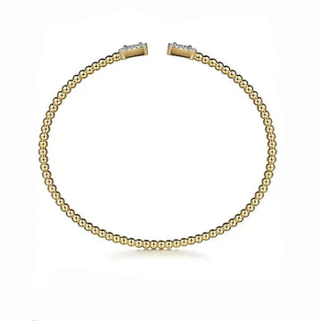 14K gold beaded cuff bracelet featuring diamond baguettes.
