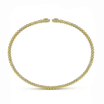 14K yellow gold beaded bangle bracelet featuring diamond flower accents.
