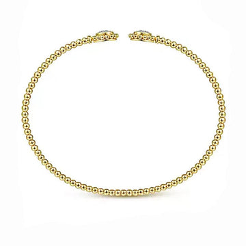 14K gold beaded bangle bracelet adorned with pave diamond accents.
