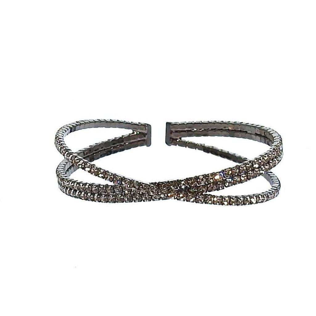 Silver cuff bracelet with three rows of sparkling crystals, crisscross design.
