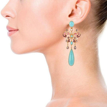 Woman's profile showcasing teardrop amazonite gemstone earrings with butterfly accents and pink & purple gemstones.

