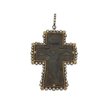 Ancient Russian cross pendant with diamond bezel; dark metal, detailed crucifix.
