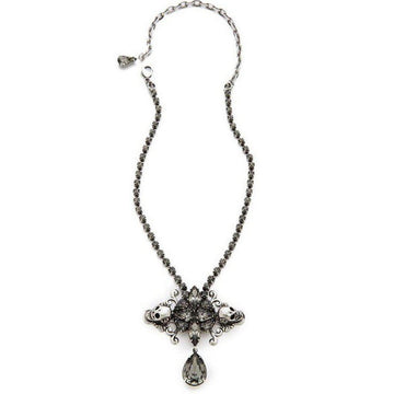 Elegant dark gray crystal pendant necklace with skull accents, featuring a teardrop charm.
