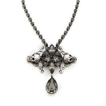 Auden Duval Pendant: Silver necklace with gray crystal skulls & teardrop pendant.
