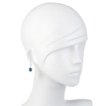 Dark blue opal drop earrings on a mannequin.
