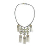 Beachcomber necklace: gold & bronze chain, off-white stones, geometric pendant with fringe accents.
