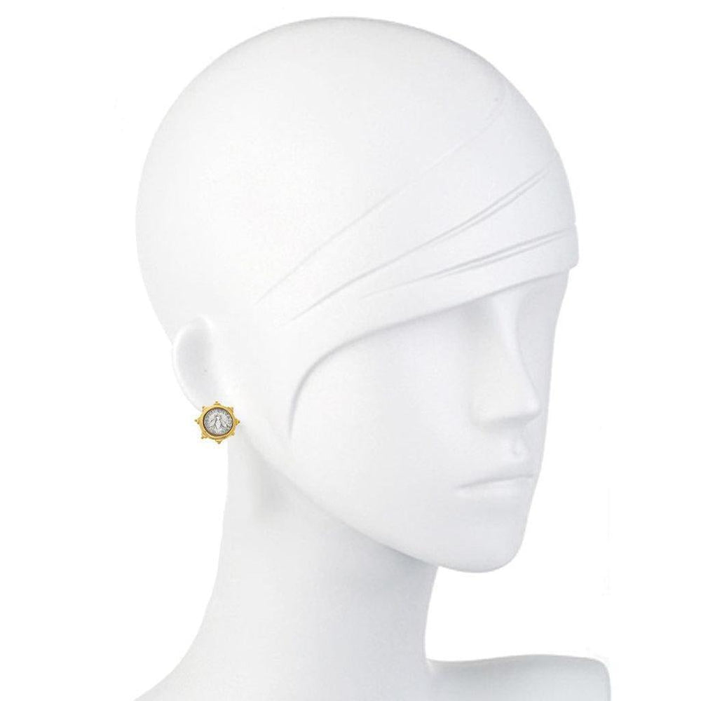 Gold coin stud earrings on a mannequin, showcasing a detailed design.

