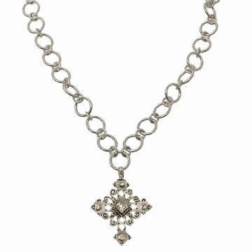 Silver chain necklace featuring an ornate cross pendant with clear stones.
