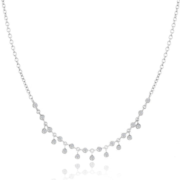 Elegant bezel diamond necklace with delicate dangling accents.
