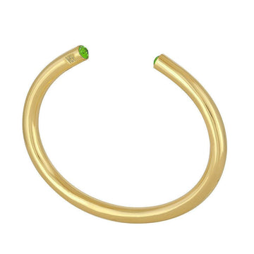 Gold bangle bracelet featuring green gemstones.
