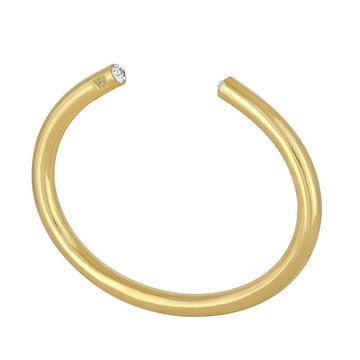 Gold cuff bracelet featuring clear cubic zirconia accents.
