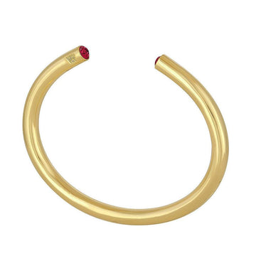 Gold bangle bracelet with ruby accents.
