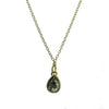 18k gold necklace featuring a pear-shaped black diamond pendant.
