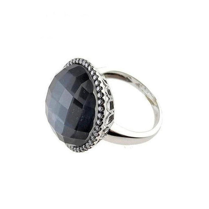 Black mother-of-pearl statement ring with silver filigree and accents.
