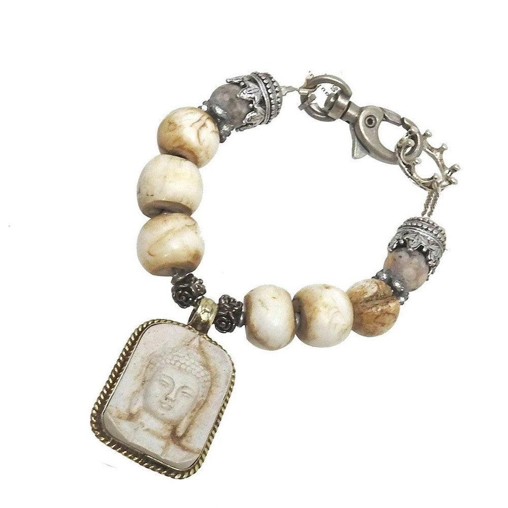 Beaded Buddha amulet bracelet with carved stone pendant; beige and brown tones.

