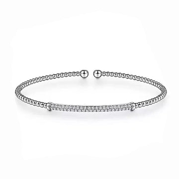 Elegant white gold beaded bangle featuring a pave diamond bar.
