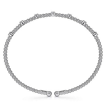 Silver beaded bangle bracelet adorned with small diamonds.
