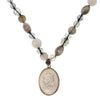 Cameo beaded necklace with gray and white stone accents and an oval cameo pendant.
