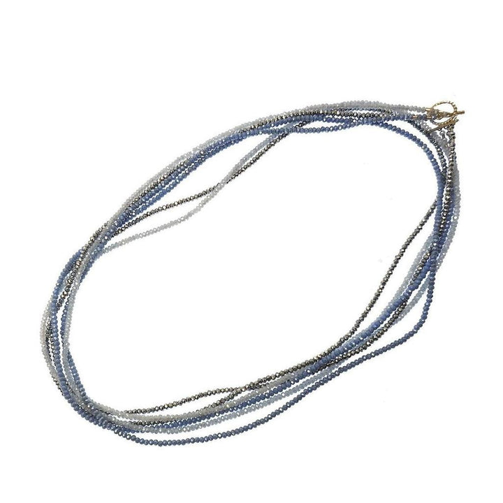 Multi-strand Cassandra necklace with ombre blue and gray crystals.
