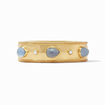 Gold hinge bangle featuring blue and white gemstones.
