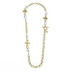 Gold chain necklace with baroque pearls and ornate cross charms.

