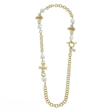 Gold chain necklace with baroque pearls and ornate cross charms.
