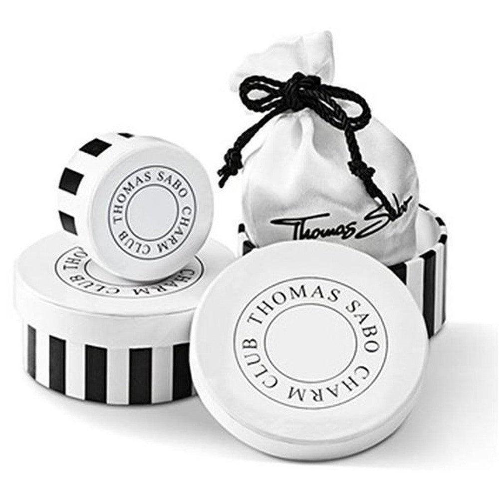 Elegant charm packaging: white satin pouch and striped boxes.
