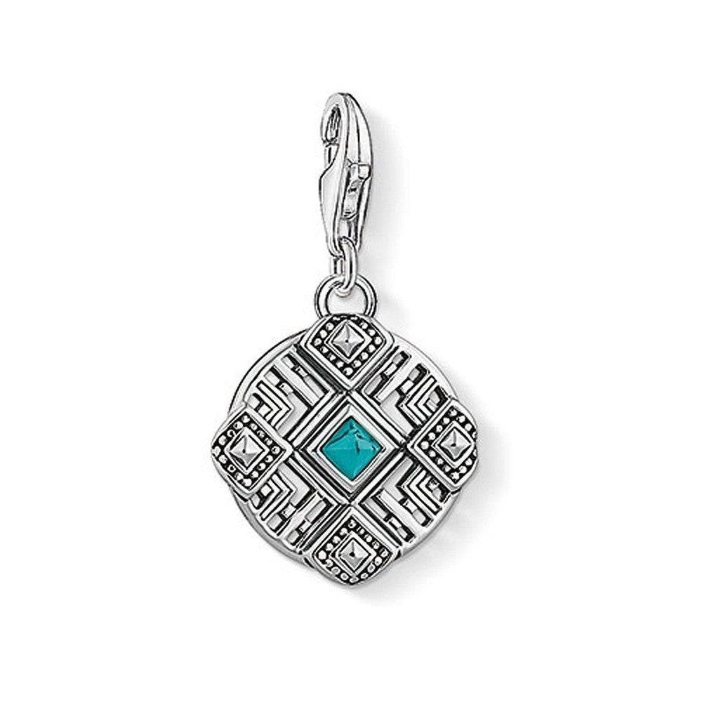 Charm 1421 Africa Ornament: Silver charm with turquoise stone, intricate geometric design.
