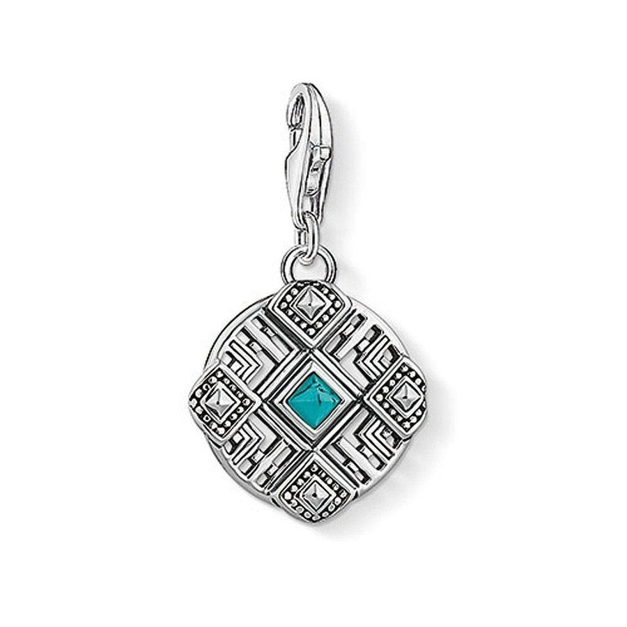 Charm 1421 Africa Ornament: Silver charm with turquoise stone, intricate geometric design.
