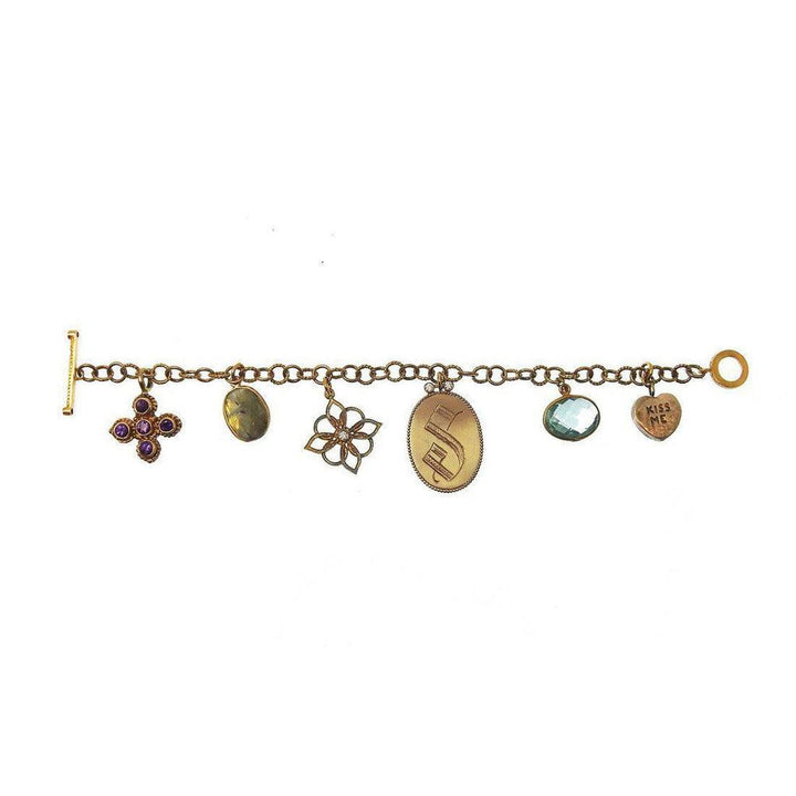 Bronze charm bracelet with amethyst and aquamarine accents.

