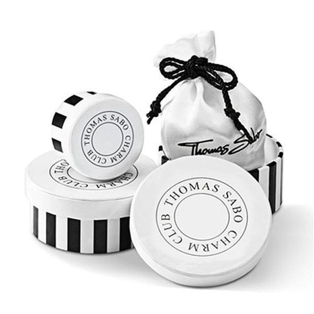 Pink charm bracelet in elegant black and white striped packaging.
