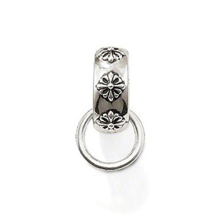 Charm Carrier Rebel At Heart silver charm, featuring floral accents and a ring.
