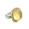 Gold-bordered citrine ring featuring a large, faceted gemstone.
