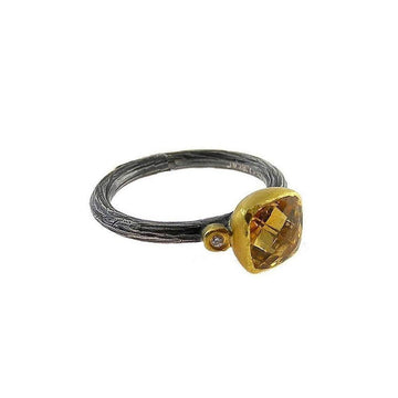 Rustic oxidized silver band ring featuring a golden cushion-cut citrine and accent diamond.

