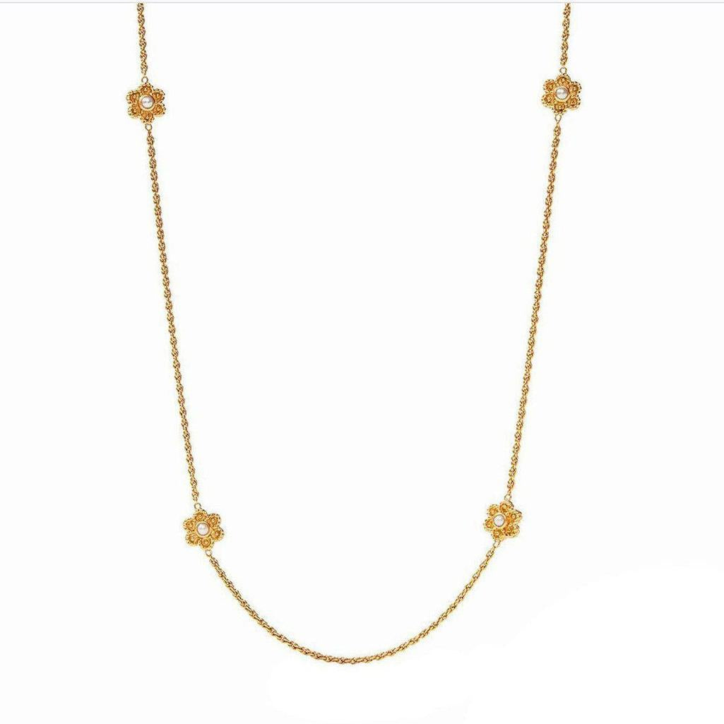 Gold Colette Pearl Station necklace featuring four floral accents with pearls.
