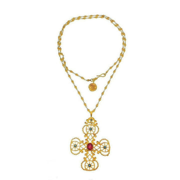 Gold cross necklace with red and blue gemstone accents, delicate chain.
