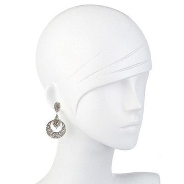 Elegant silver deco clip earrings displayed on a mannequin.
