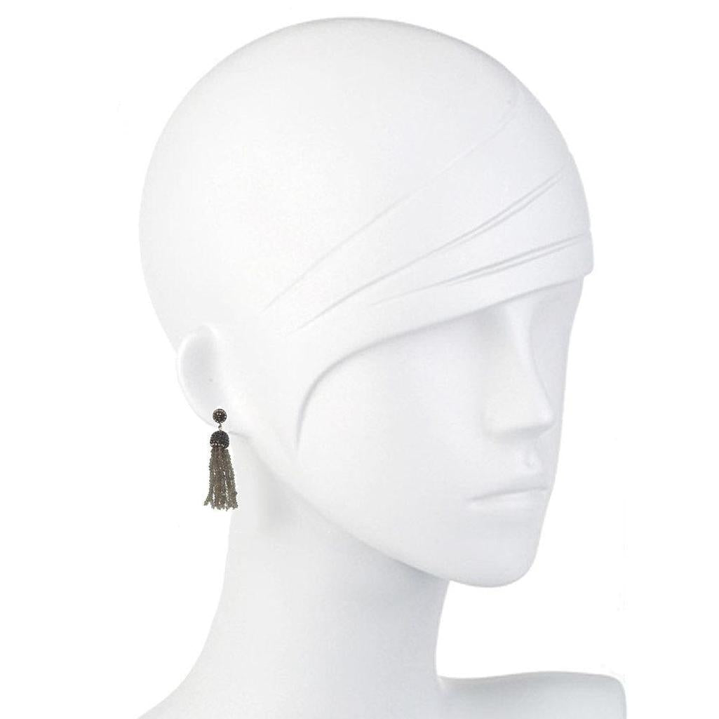 Labradorite tassel earrings on a mannequin, showcasing dark gray gemstone accents.
