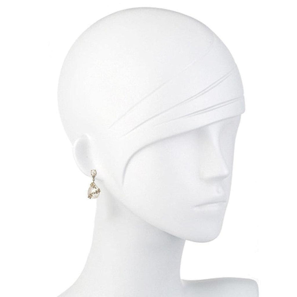 Elegant drop earrings featuring crystal and pearl accents on a mannequin.
