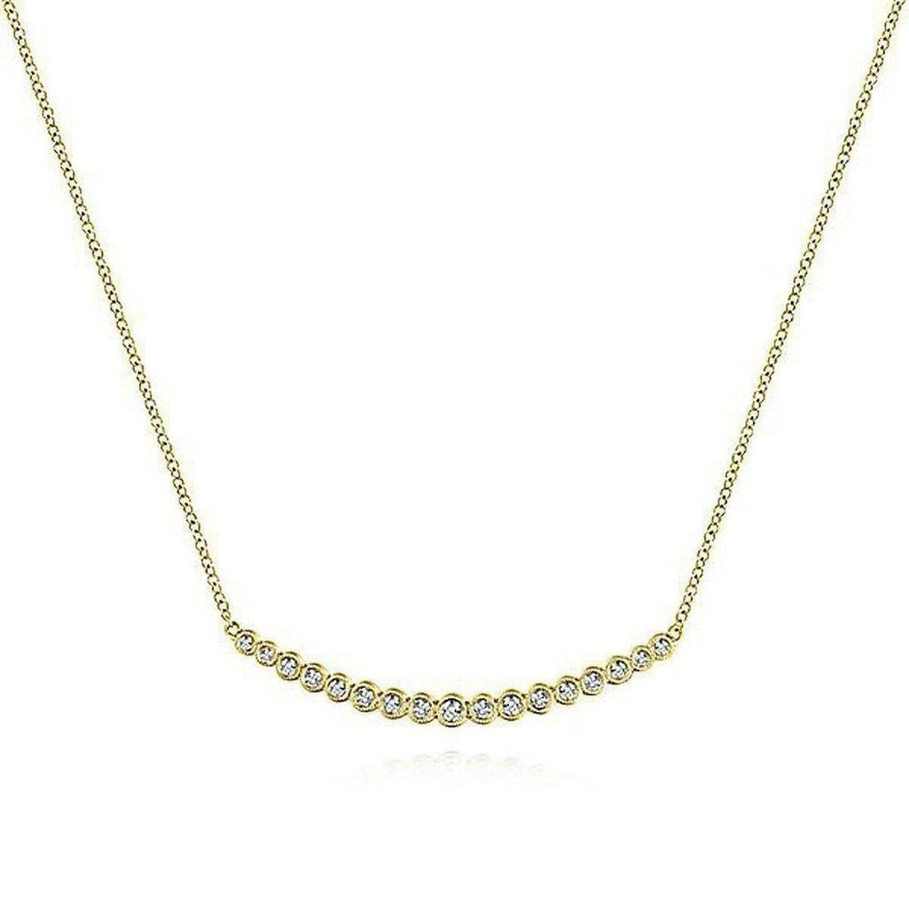 Curved diamond bar necklace in 14k yellow gold with bezel-set diamonds.

