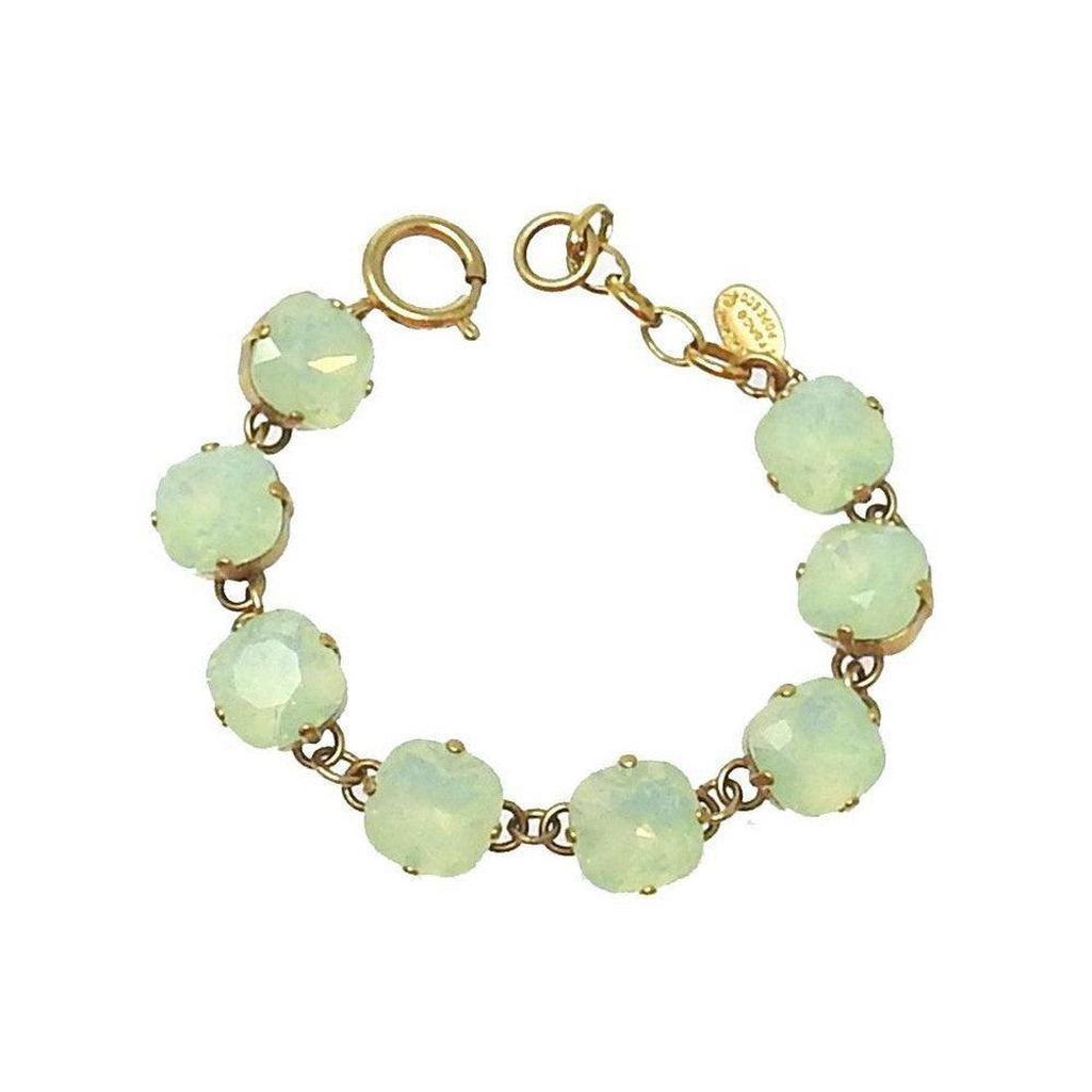 Cushion cut tennis bracelet in pale green opal, gold chain.
