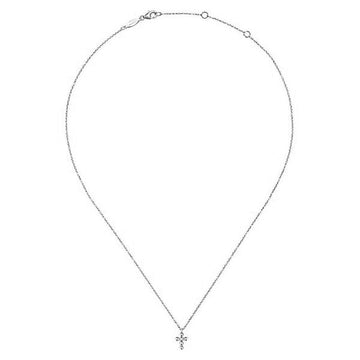 Dainty white gold necklace featuring a small diamond cross pendant.
